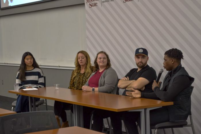 Agency founder in a panel conversation with other speakers
